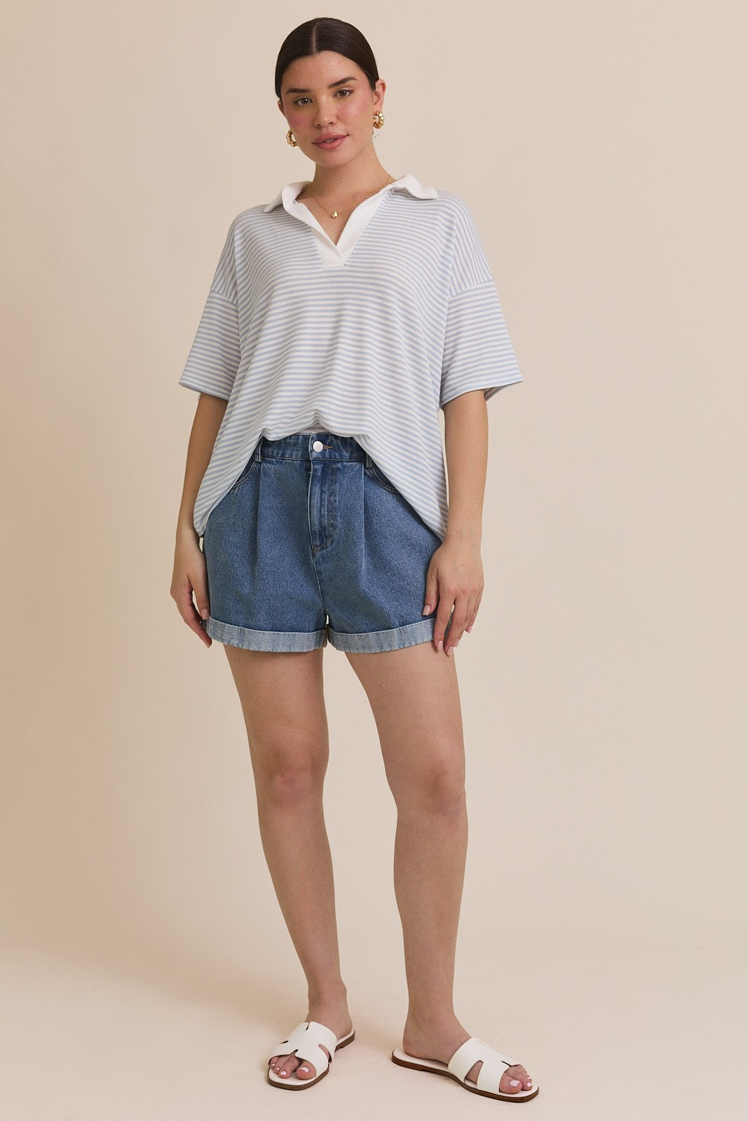 A blue and white striped polo shirt with a drop shoulder sleeve