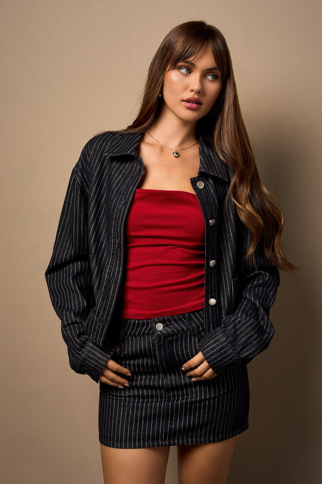 a dark denim jacket with a white stripe detail.