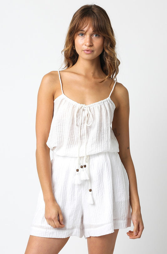 A lightweight, woven white sleeveless top featuring a tie detail