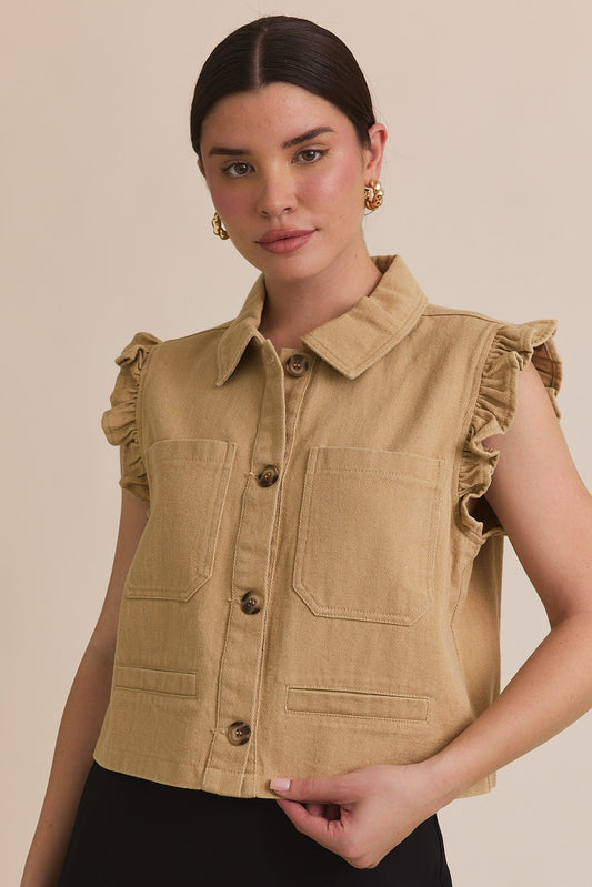 A sleeveless tan twill vest jacket with a ruffle detail