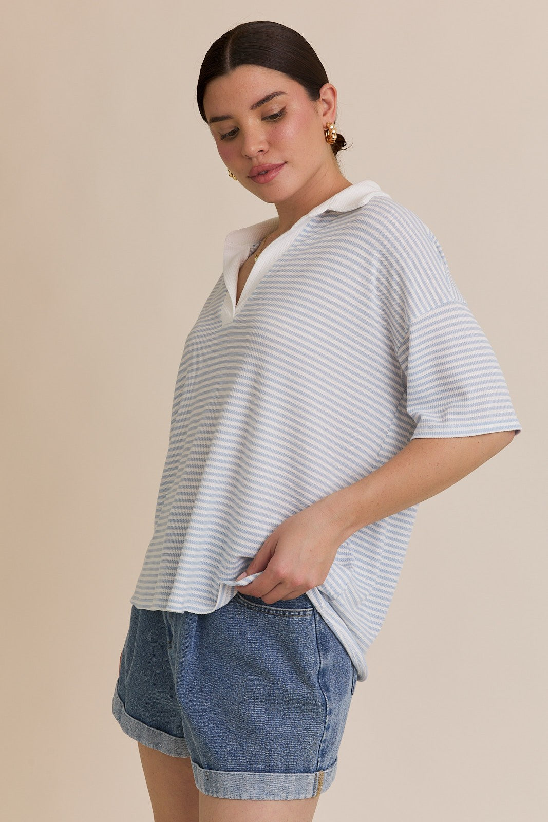 A blue and white striped polo shirt with a drop shoulder sleeve